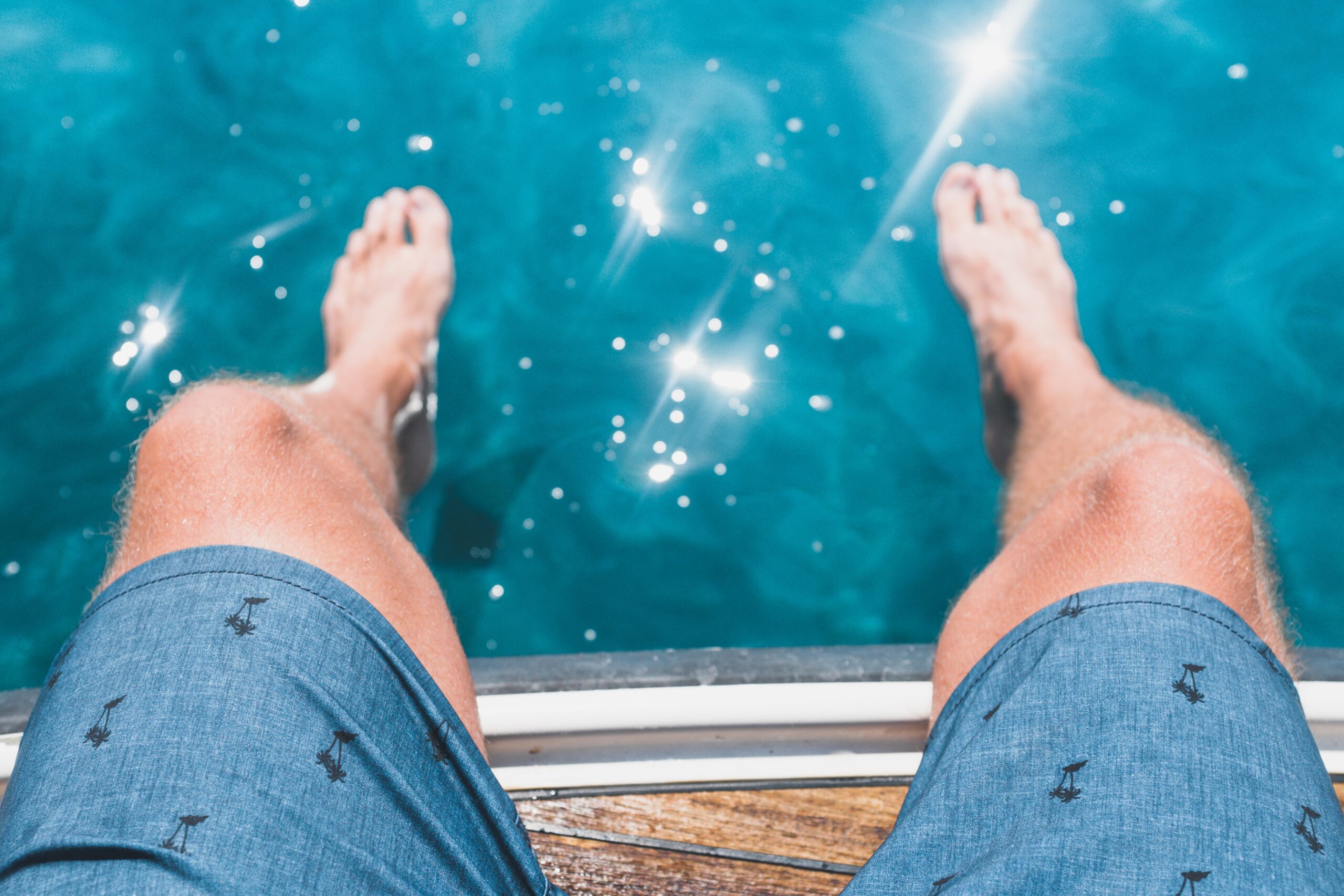 man's knees over a pool