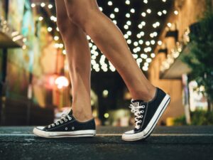 woman showing knees and black tennis shoes