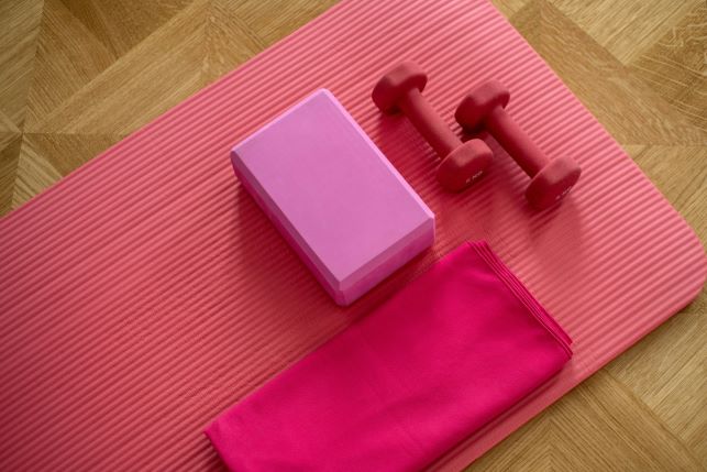 pink yoga mat, yoga block and hand weights